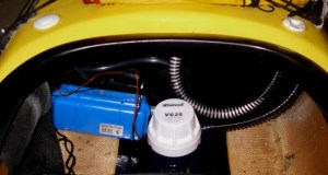 The electric bilge pump and battery case in place in the kayak