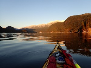 Looking over the kayak's bow up a calm inlet
