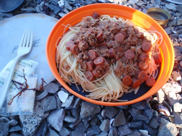 spaghetti with tomato and pepperoni coins