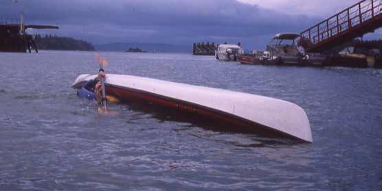A paddler in an inverted kayak sets up a roll