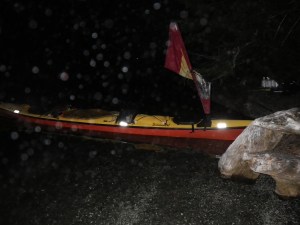 a sea kayak afloat by the shore