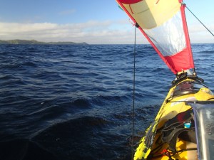 paddler's eye view of a sea kayak sailing