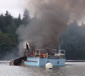 an anchored boat on fire
