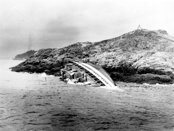 A shipwreck on a rocky islet