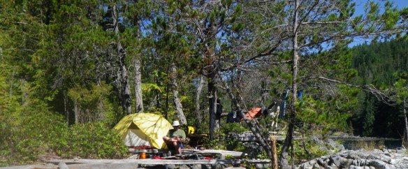 a camper relaxing in front of his tent