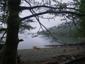 a sea kayak beached on a pebble shoe