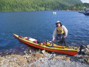a kayaker launches his boat 