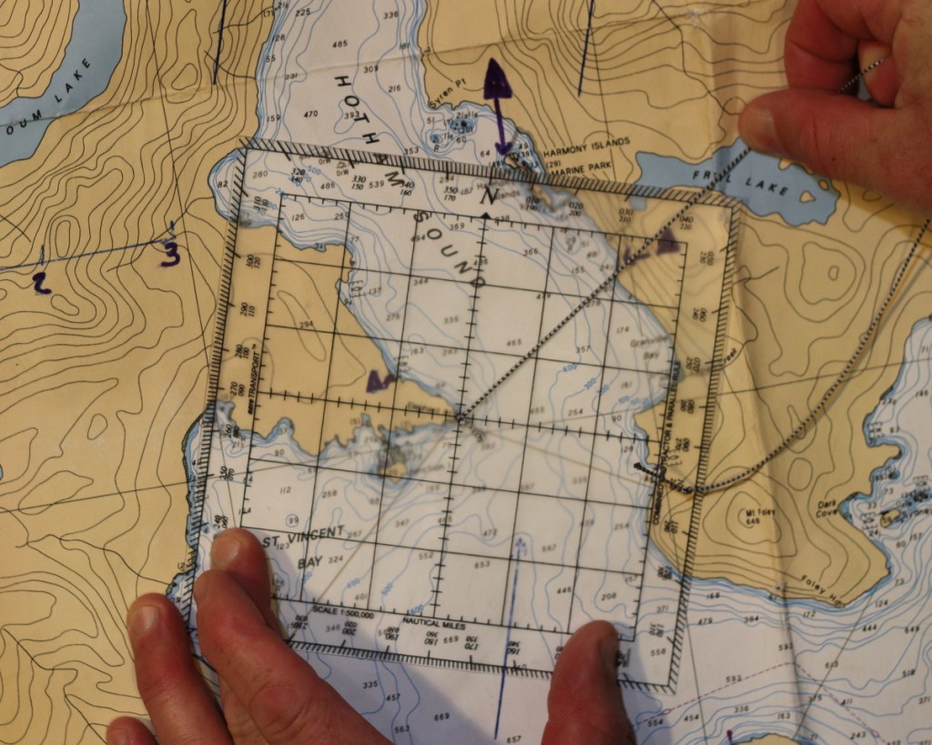 A section of nautical chart, with a Davis protractor, showing how to determine the compass bearing from one location to another.