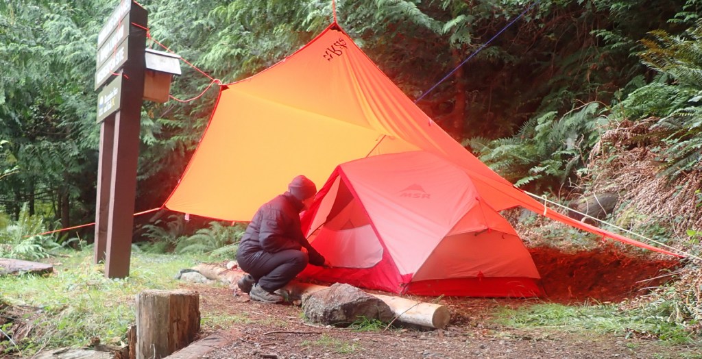 a tent with a sheltering overtarp to reduce internal condensation